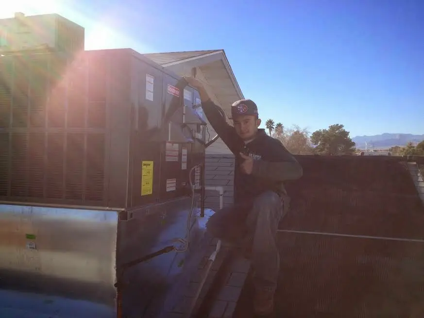 HVAC technician performing Boiler Repair on a rooftop unit in West Chicago